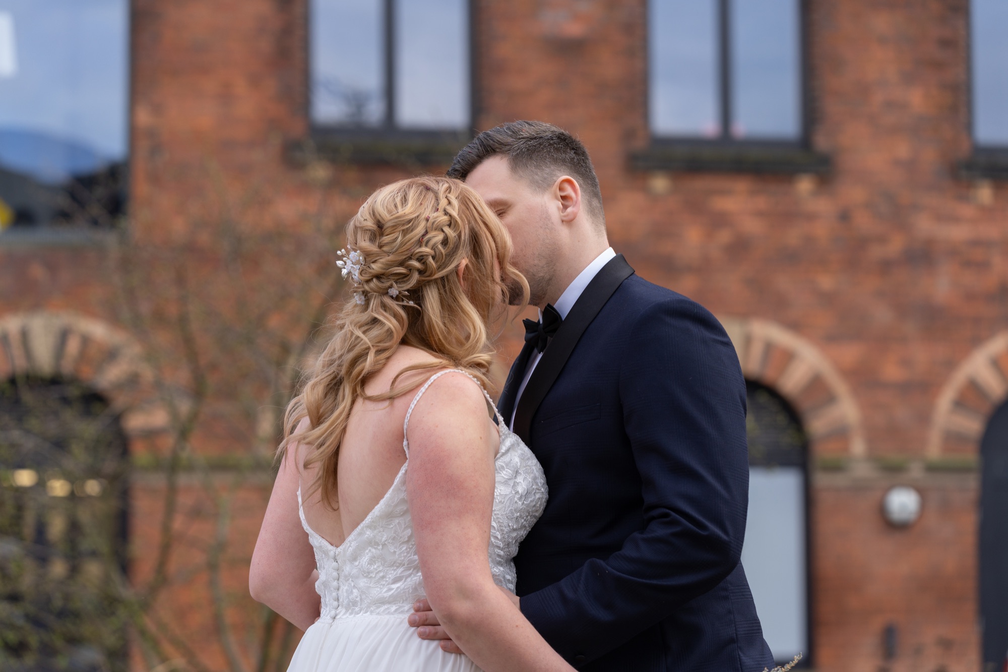 The bride and groom sharing a tender forehead-to-forehead moment outdoors