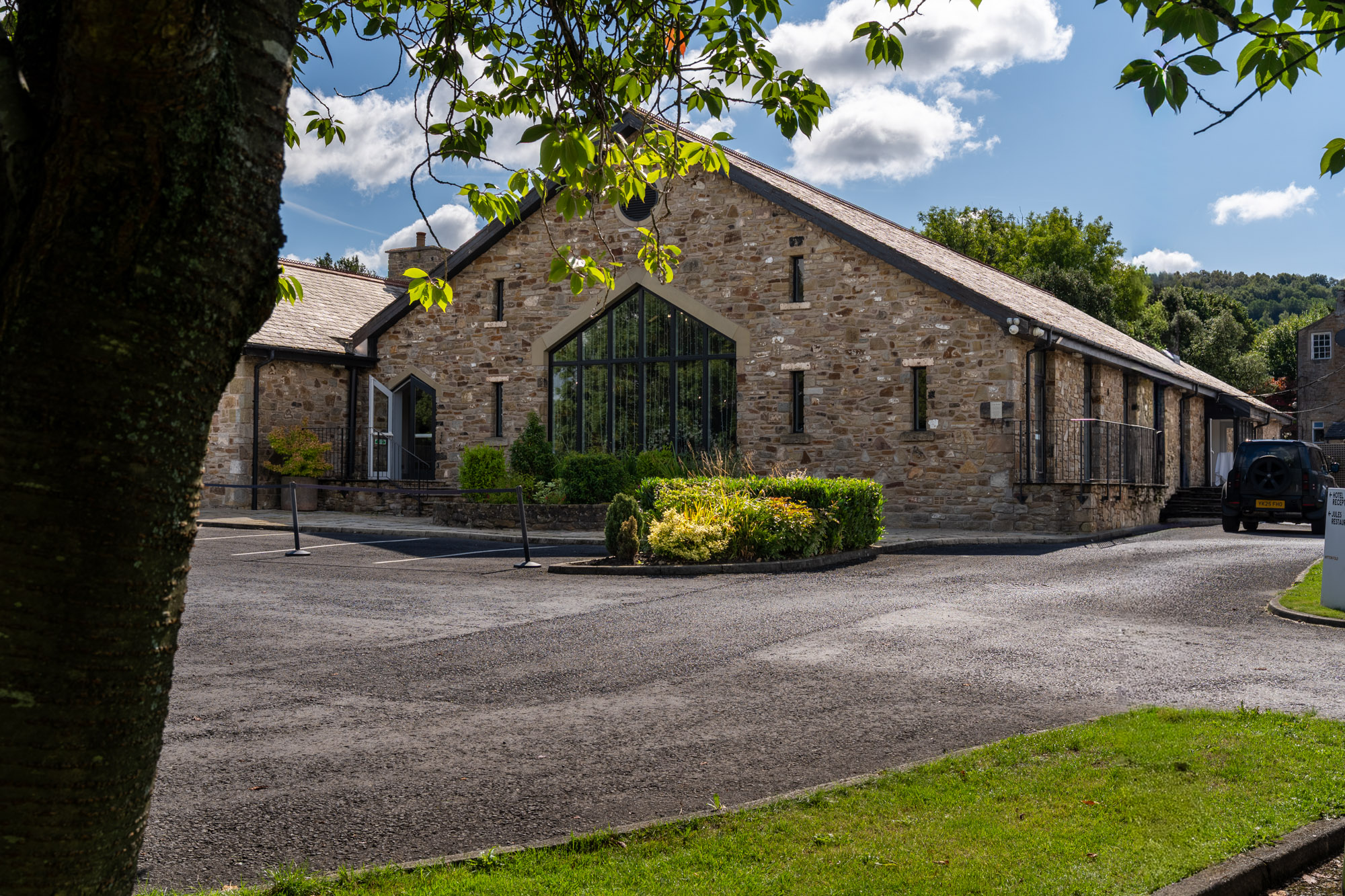 Stone wedding suite at Mytton Fold Hotel framed by mature trees