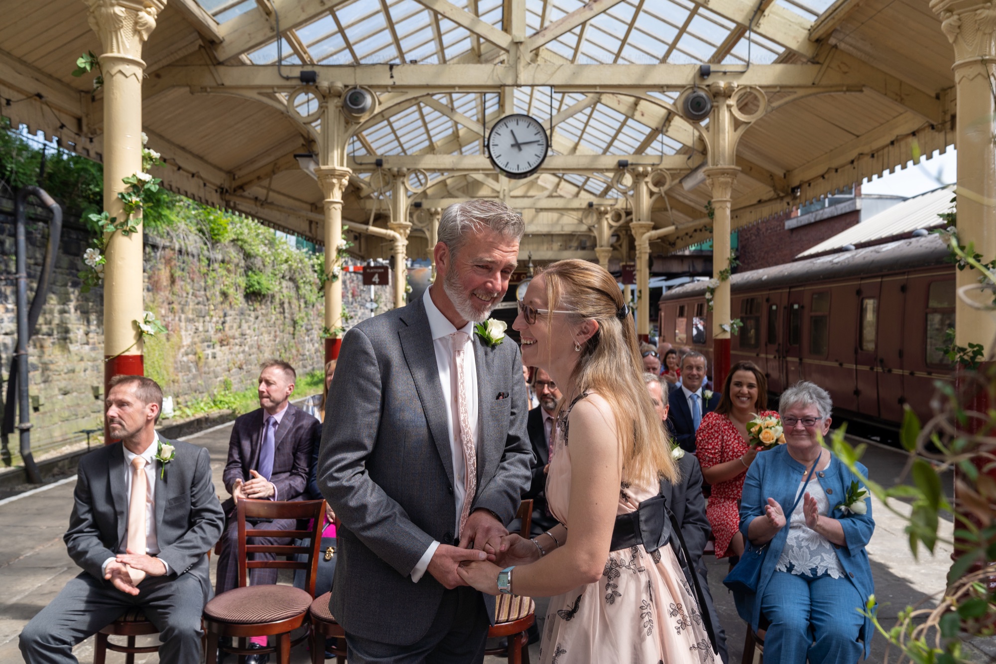 Bride and groom standing close together during the exchange of vows on the platform