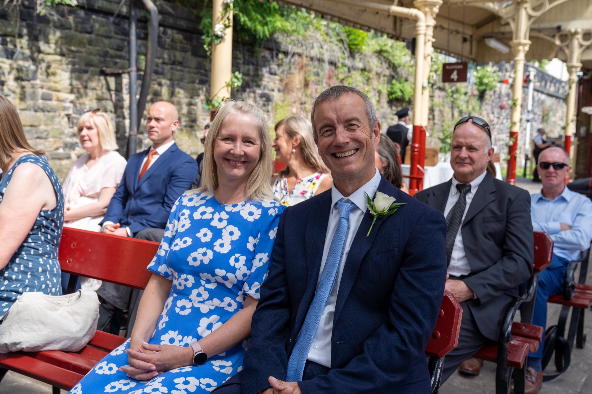 Registrar confirming the marriage with the couple on the platform, maroon carriage in the background