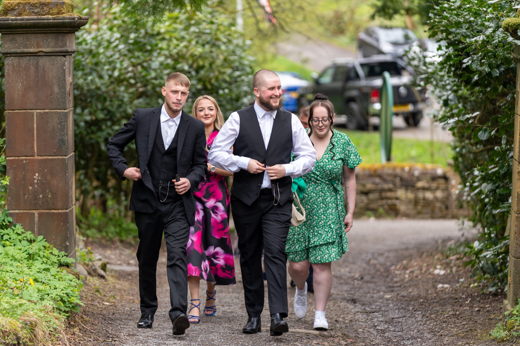 Wedding guests walking along the woodland path into Sunnyhurst Wood on their way to the ceremony.