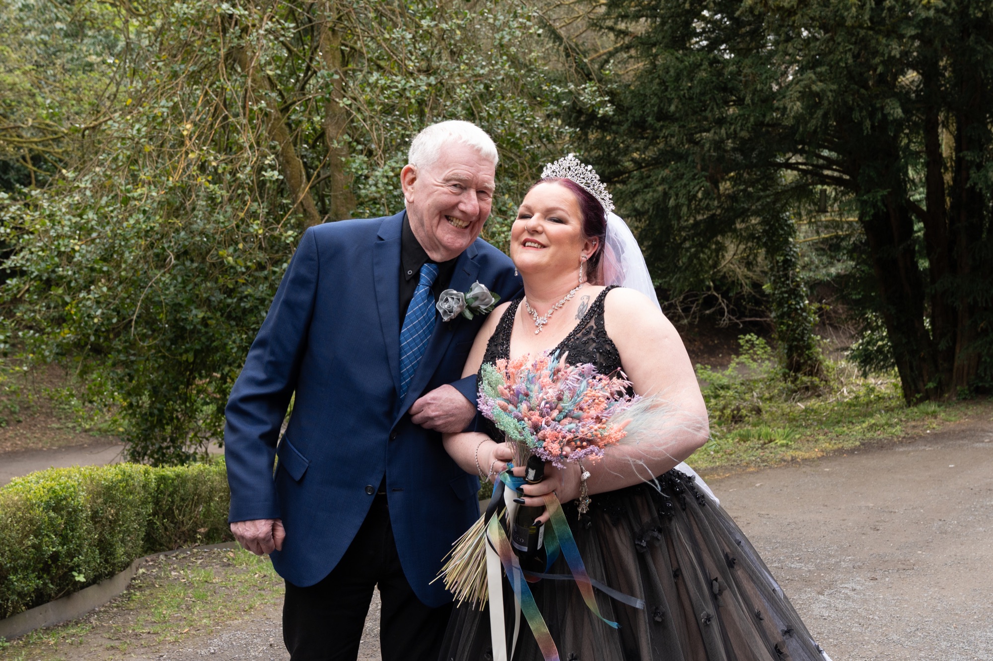 The bride and groom share a close moment with a family member after the ceremony.