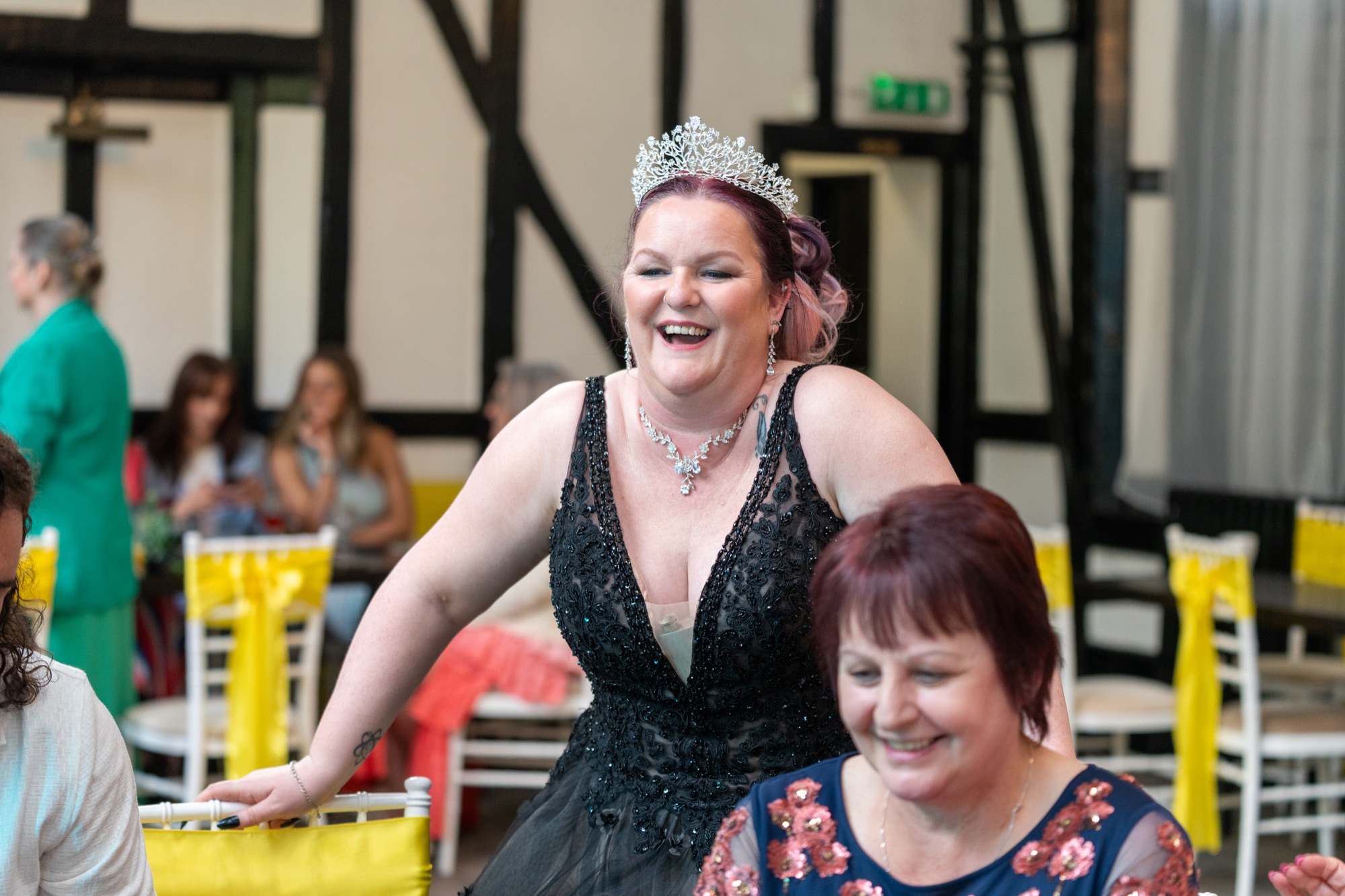 The bride laughs and dances with guests during the evening party.