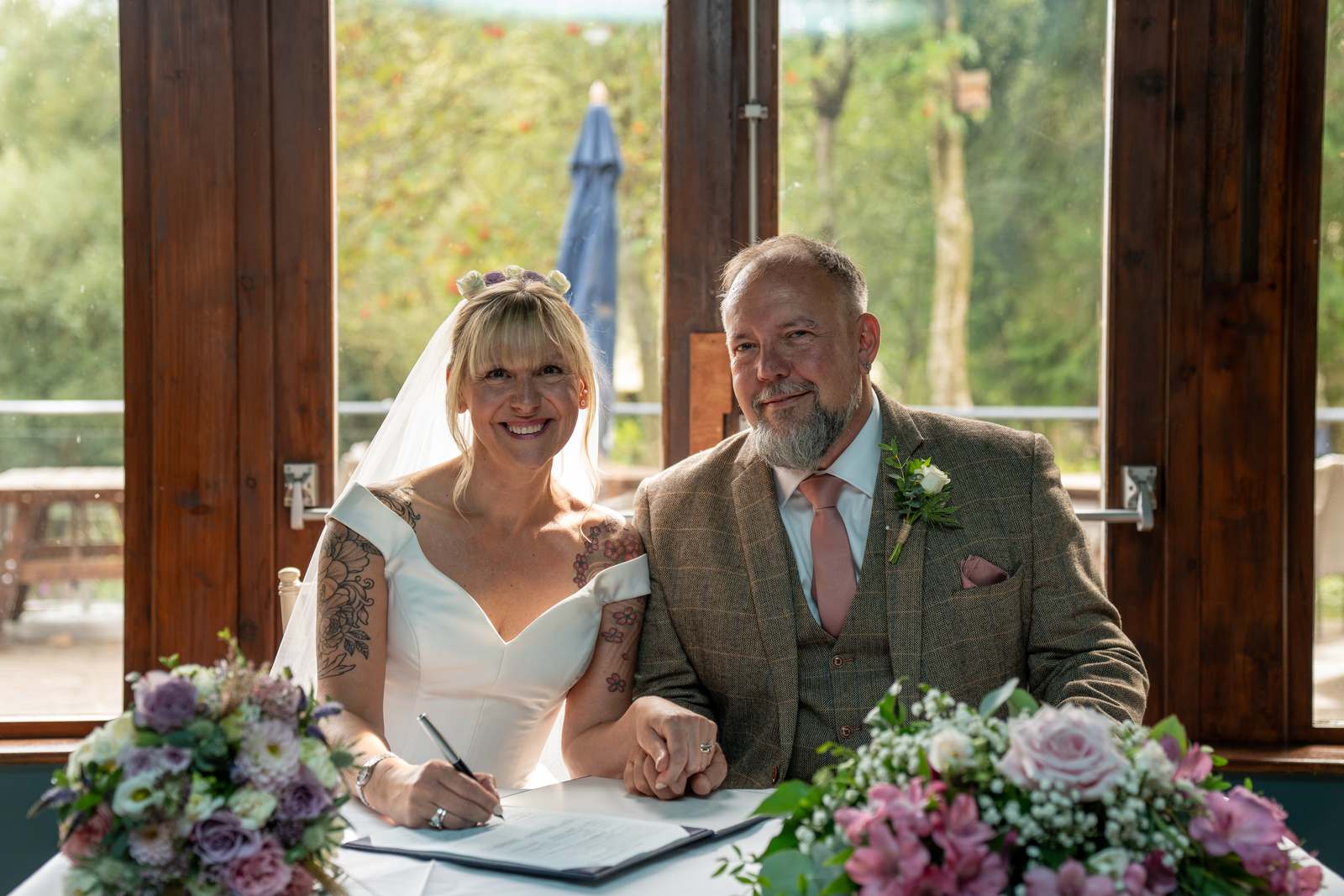 Chris and Mandy signing the register after their ceremony