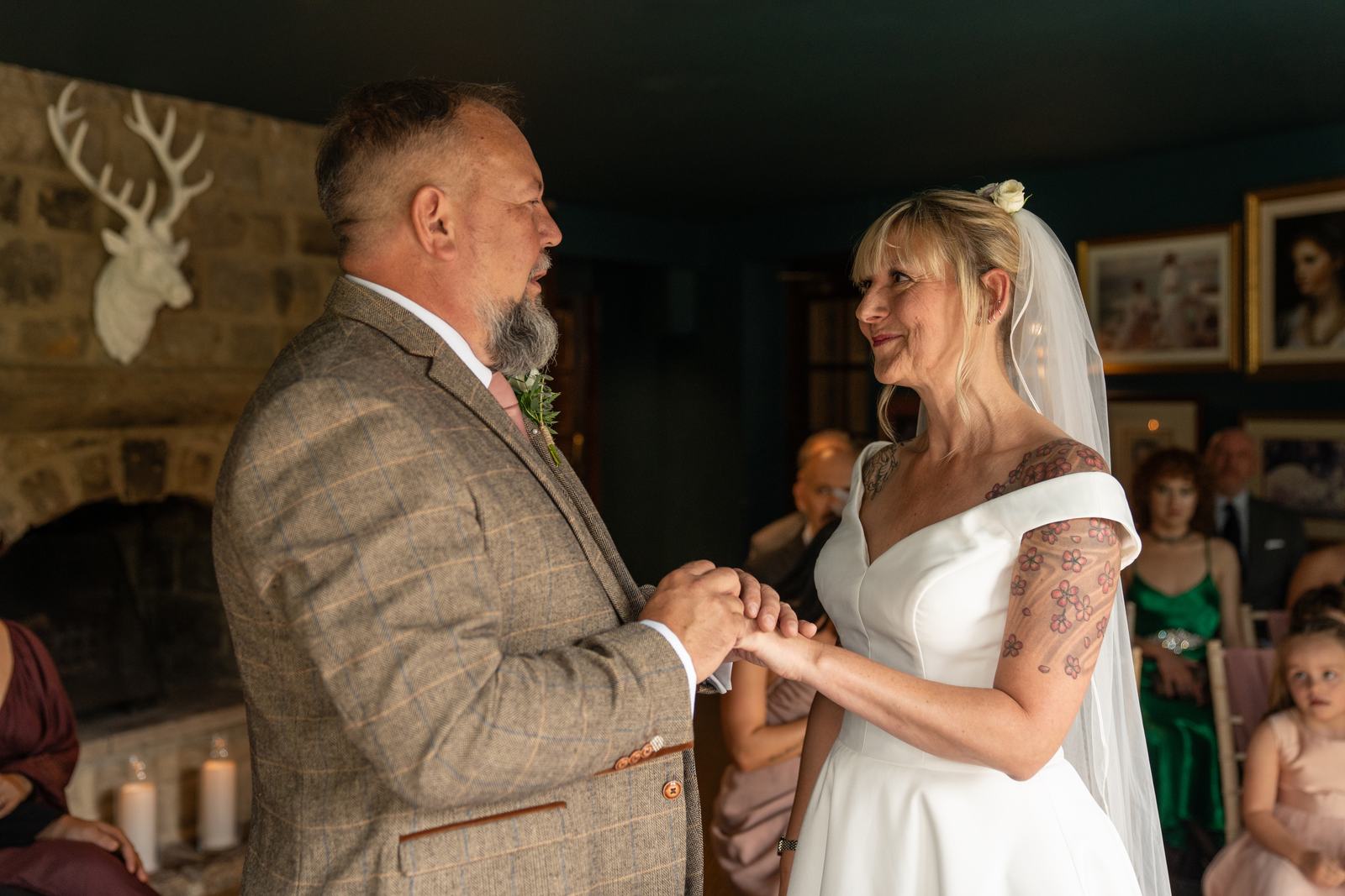 Chris and Mandy exchanging rings during their wedding ceremony