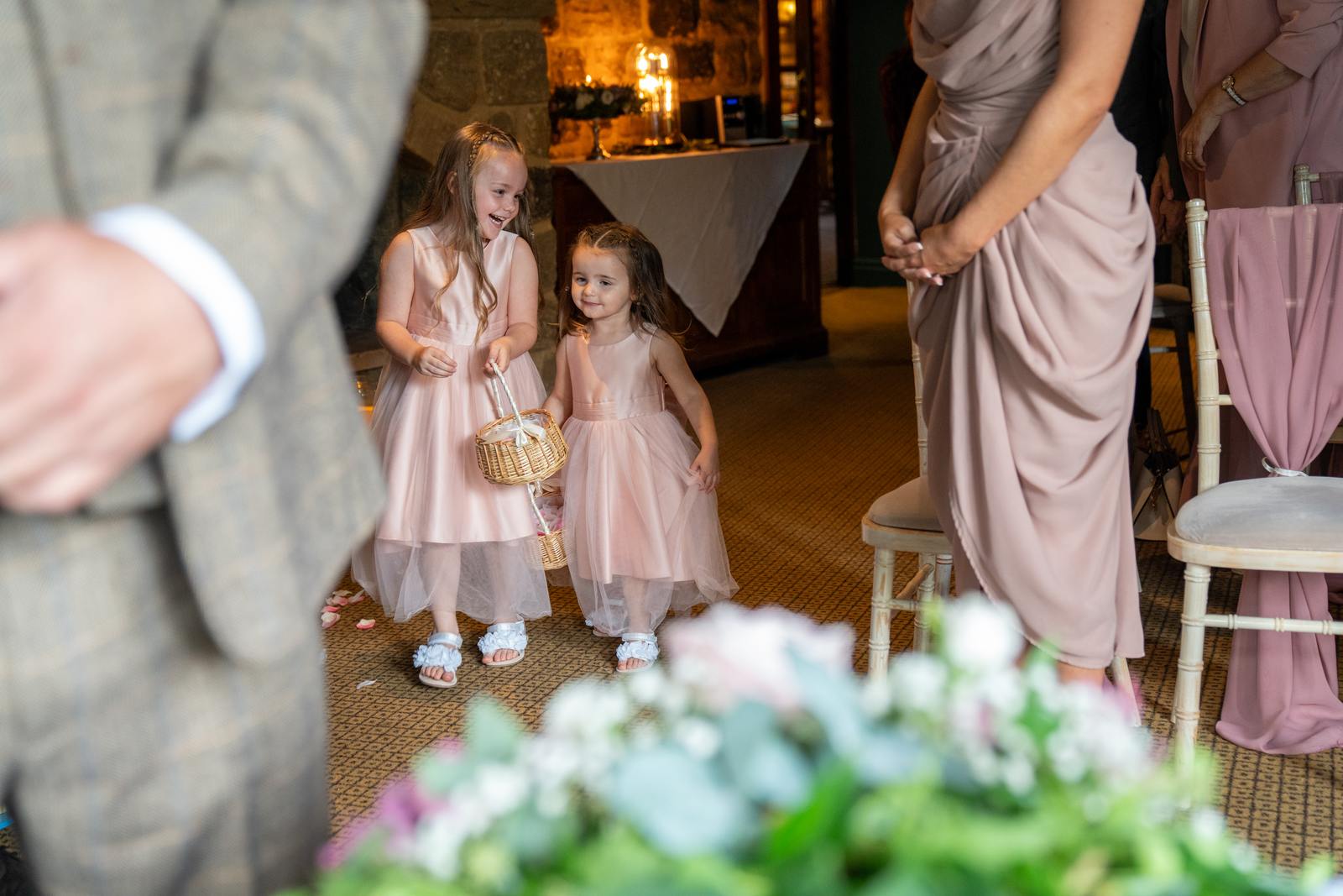 Flower girls walking down the aisle ahead of the bride at Chris and Mandy's ceremony