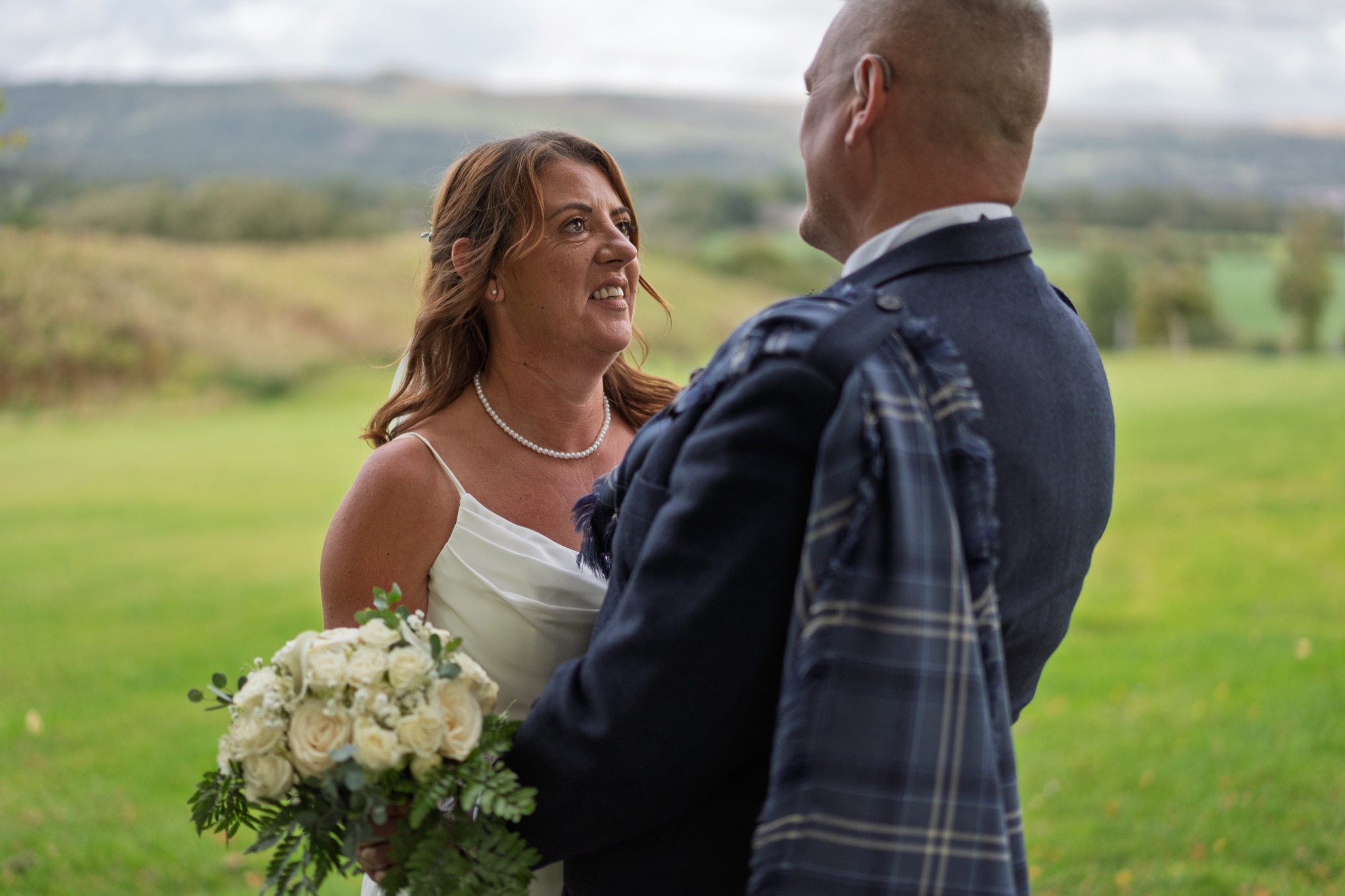 Bride and groom laughing together during their portrait session