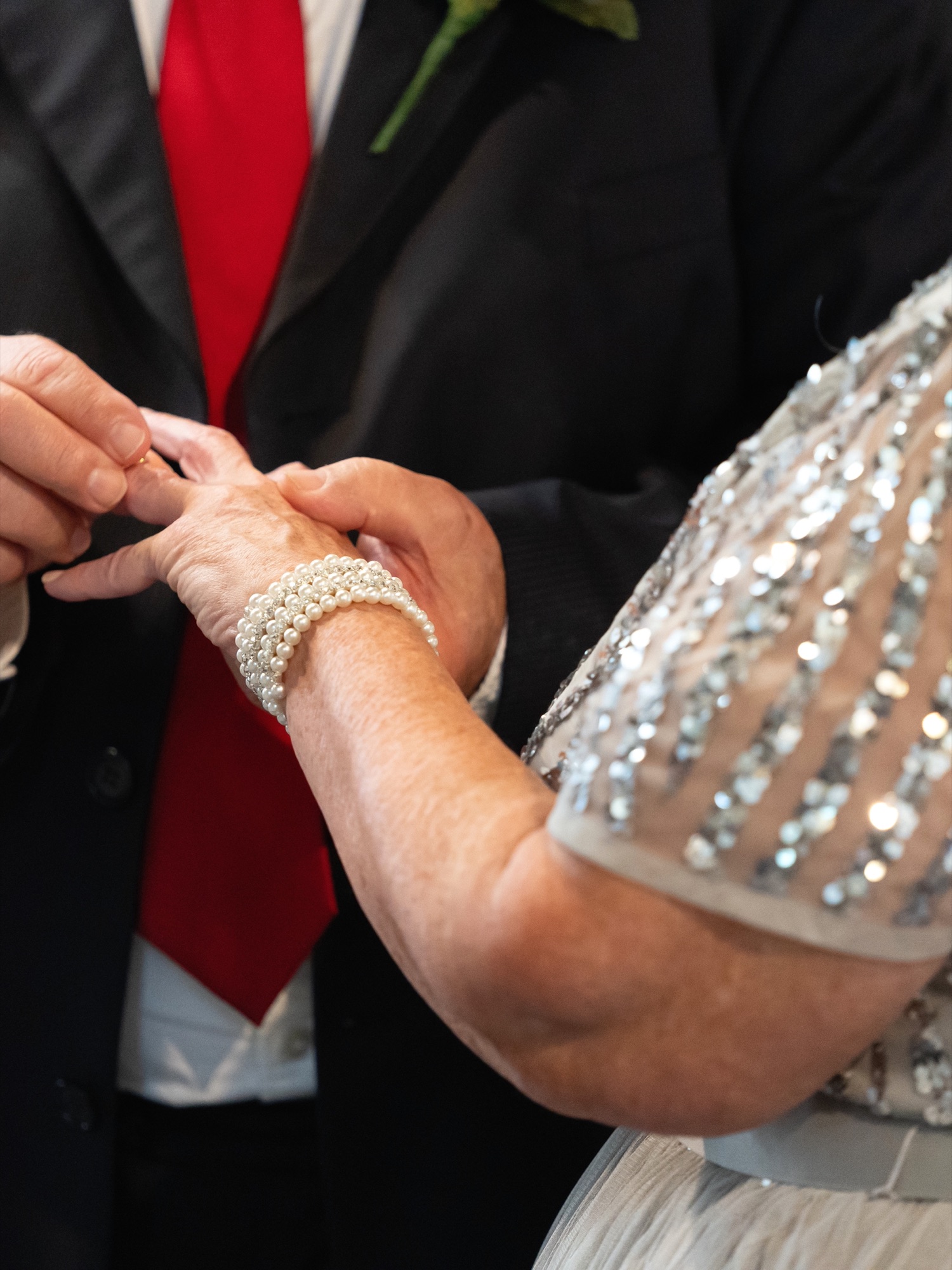 Close-up of the groom placing the wedding ring on the bride's finger